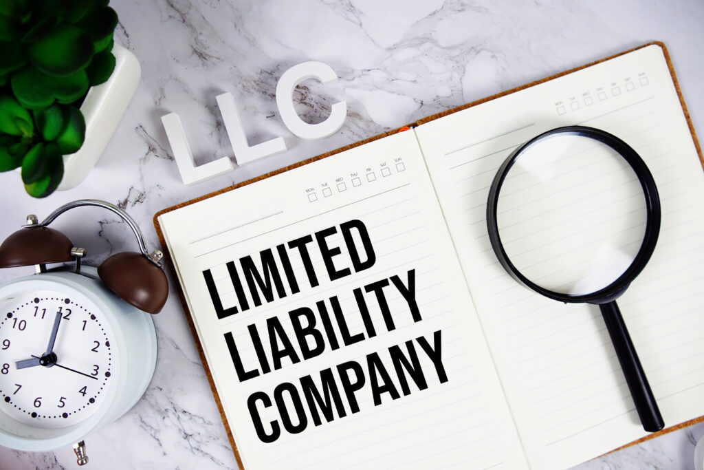 LLC - Limited Liability Company acronym on notepad Business concept background LLC - Limited Liability Company acronym on notepad Business concept background