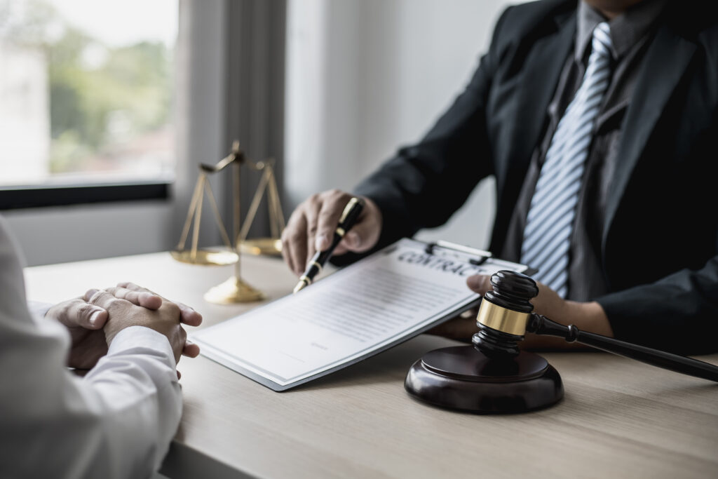 Attorney gives the client a pen to sign a contract admitting fraud lawyer admits a fraud case in which client is a victim and will sue defendant who is a commercial partner Fraud litigation concept Attorney gives the client a pen to sign a contract admitting fraud lawyer admits a fraud case in which client is a victim and will sue defendant who is a commercial partner Fraud litigation concept