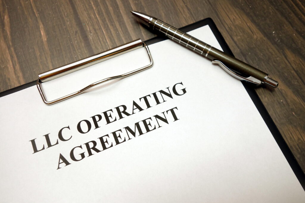 Clipboard with llc operating agreement and pen on desk